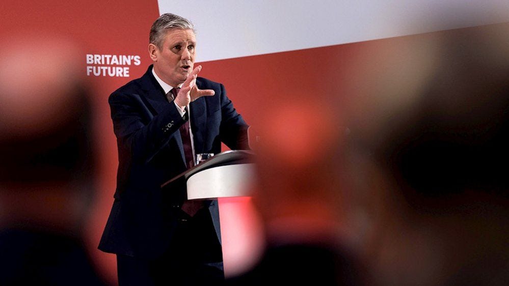 Keir Starmer pictured wearing a suit while talking to a crowd in front of a red backdrop at the Labour business conference in London on 1 February