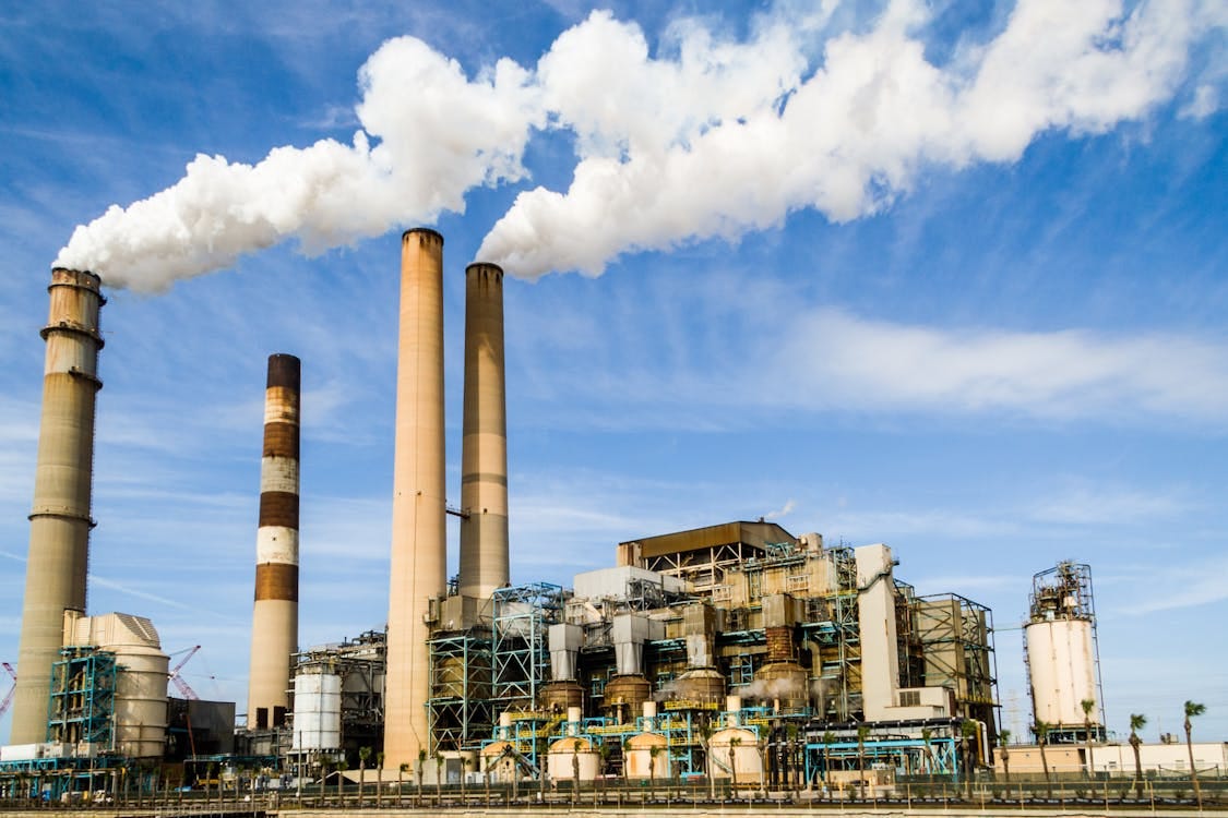 Free Photo Of An Industrial Factory Emitting Smoke Stock Photo