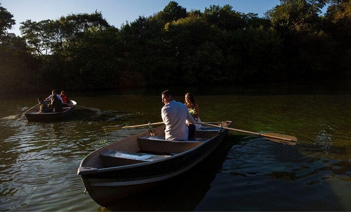 Boaters enjoy rowing on a Central Park pond.