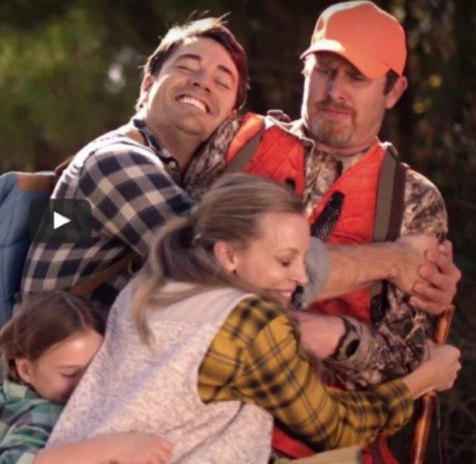 A happy family hugging a surprised hunter.