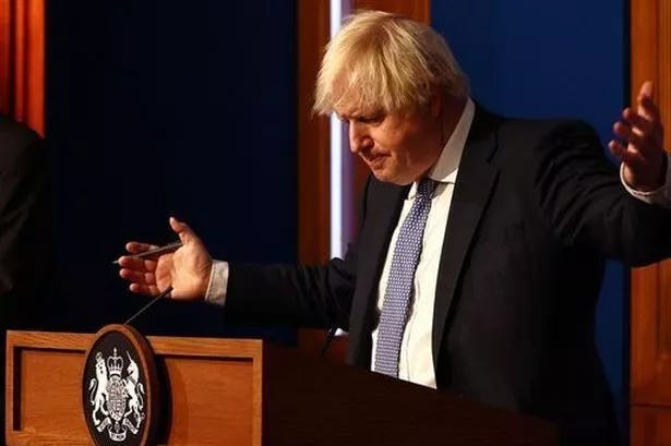 Prime Minister Boris Johnson gestures whilst speaking at a press conference in London's Downing Street after ministers met to consider imposing new restrictions in response to rising cases and the spread of the Omicron variant. Picture date: Wednesday December 8, 2021.