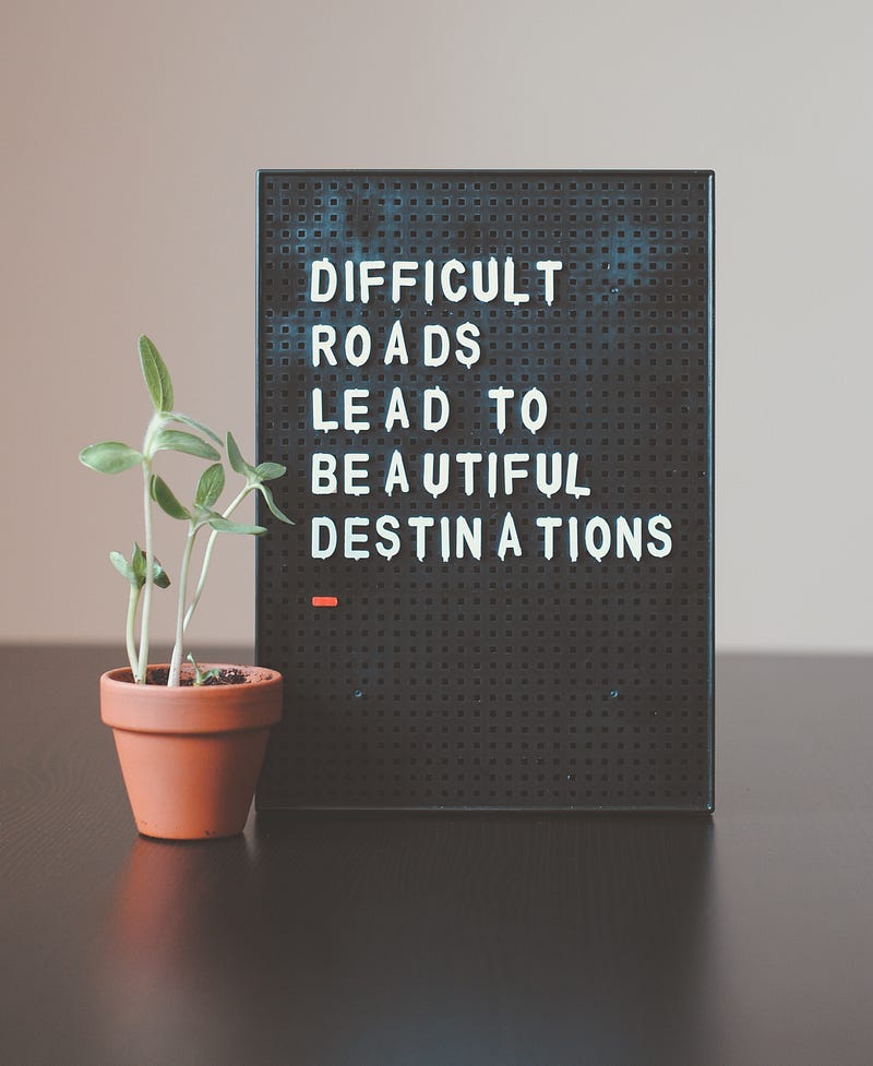 difficult roads lead to beautiful destinations sign.