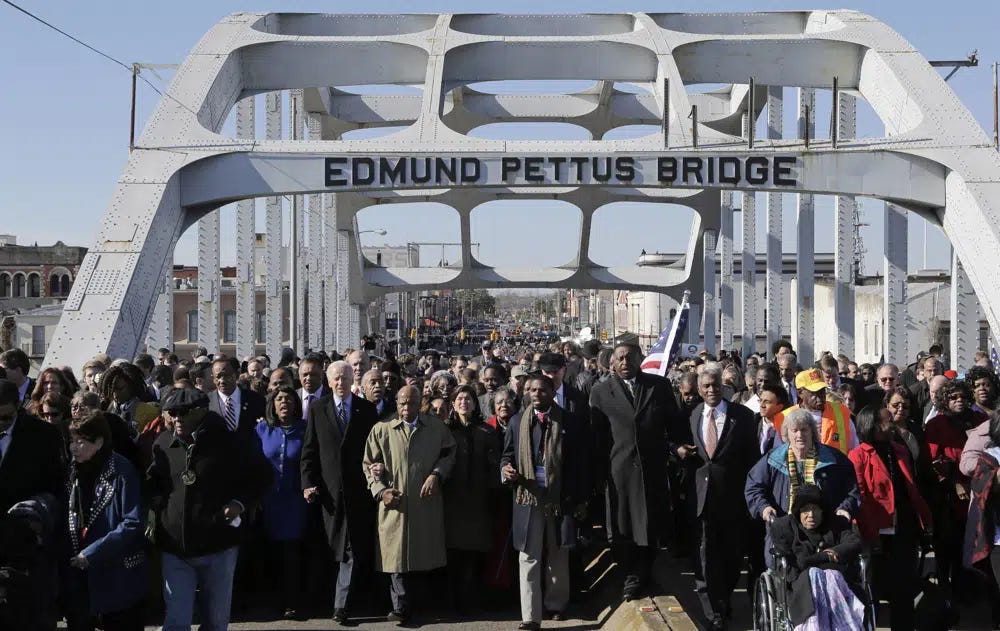 FILE - Vice President Joe Biden and U.S. Rep. John Lewis, D-Ga., lead a group across the Edmund Pettus Bridge in Selma, Ala., March 3, 2013. President Joe Biden on Sunday, March 5, 2023, is set to pay tribute to the heroes of “Blood Sunday," joining thousands for the annual commemoration of the seminal moment in the civil rights movement that led to passage of landmark voting rights legislation nearly 60 years ago. (AP Photo/Dave Martin, File)