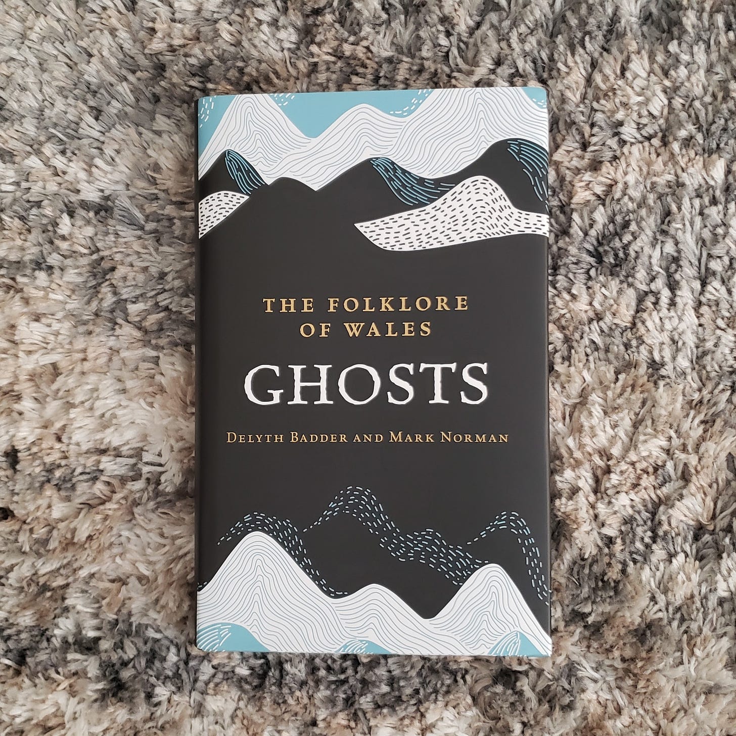 Photo of book, The Folklore of Wales: Ghosts by Delyth Badder and Mark Norman.