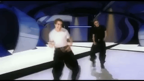 Joey is dancing with Chris behind him; they're doing some move where they fling their arms out and Joey has a huge grin on his face
