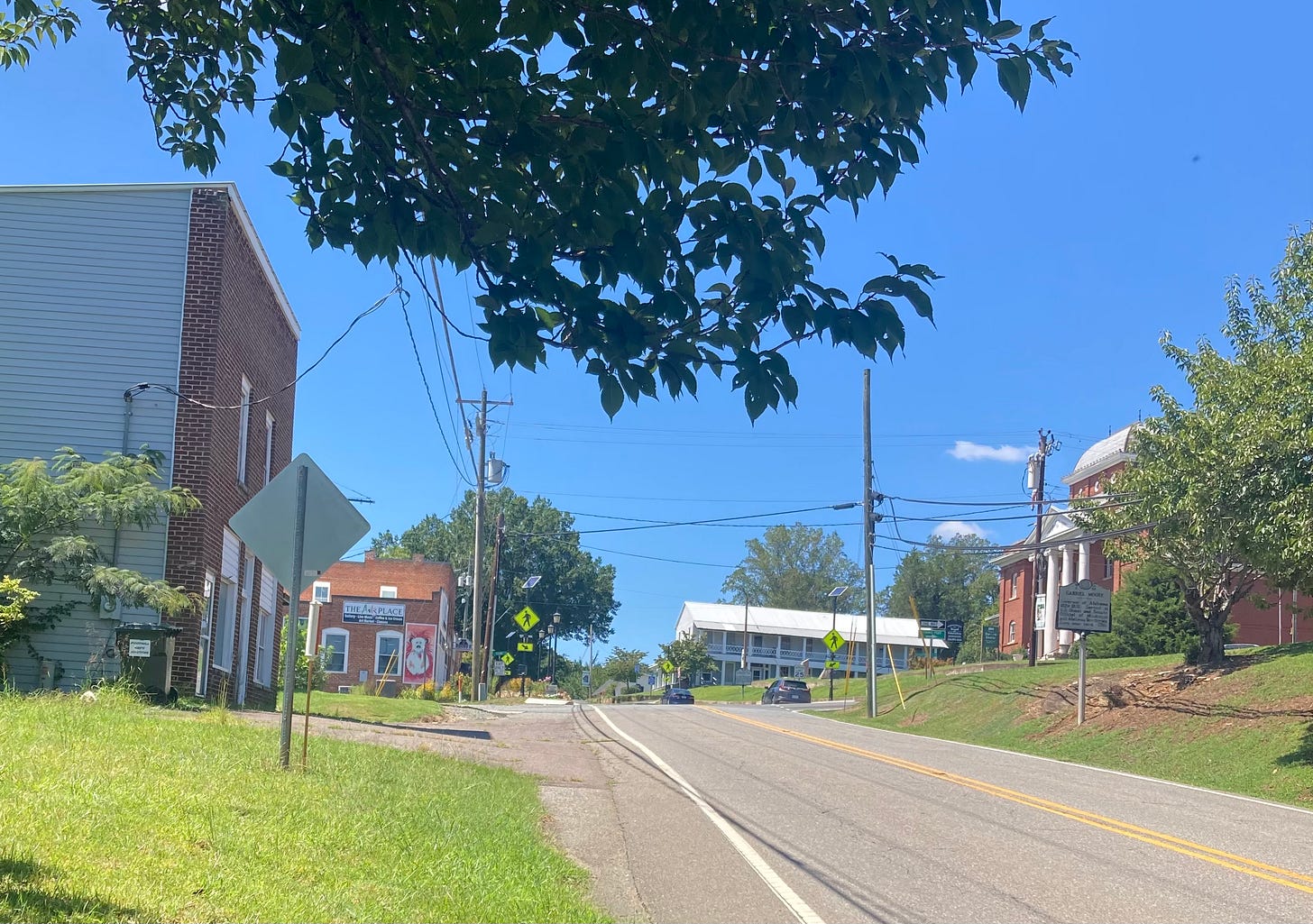 the two-lane highway leading through the historic district, brick buildings on each side, widely spaced