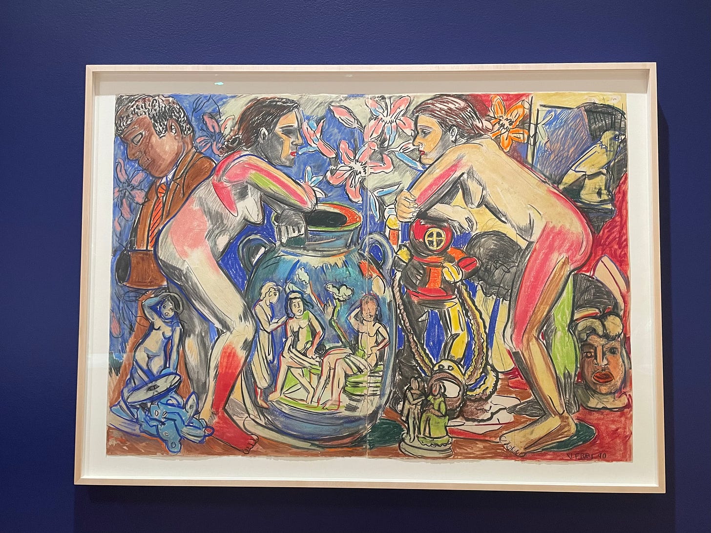 An image of Viola Frey’s Artist Mind/Studio Diptych VIII. In the center are two nude individuals, facing one another. The person on the left rests their hands atop a vase with smaller nude figures on it. The person on the right rests their hands atop an oxygen tank used for deep sea diving. Around the individuals are various objects — figurines, statues, flowers — and a man to the far left. Browns, reds, blues, pinks, white, greens, and yellows, are used throughout. 