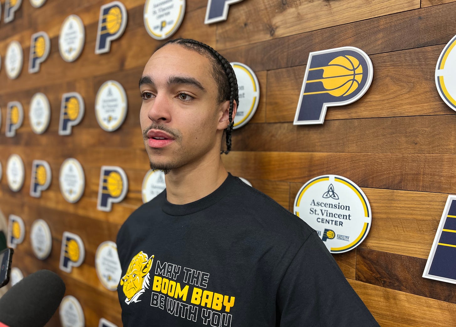 Pacers guard Andrew Nembhard talks with reporters after practice.