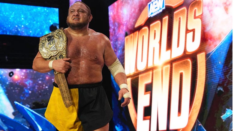 Samoa Joe with title belt on shoulder