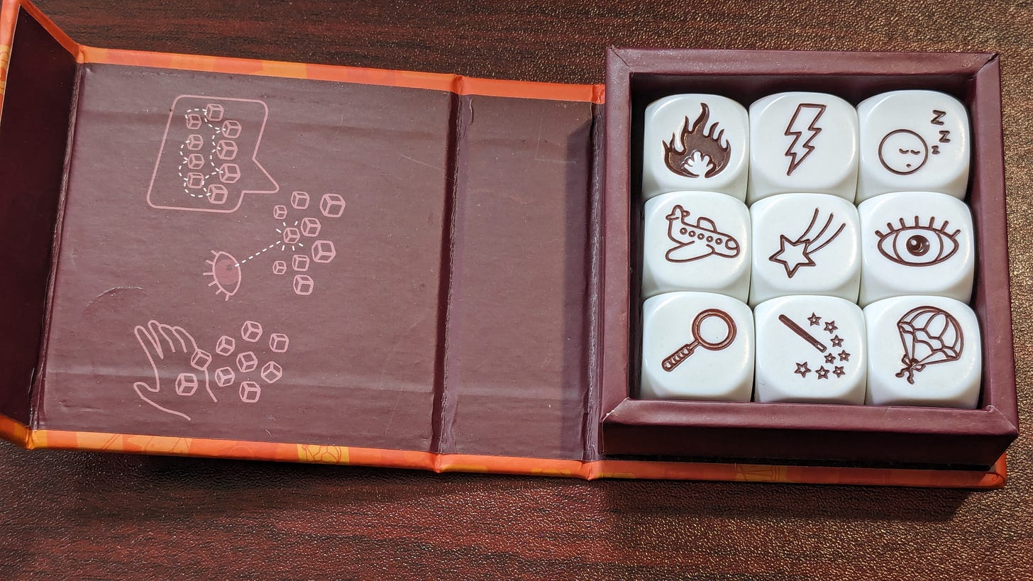 A selection of story cubes showing a fire, a lightning bolt, a sleeping person, a plane, a shooting star, an eye, a magnifying glass, a magic wand and a parachute
