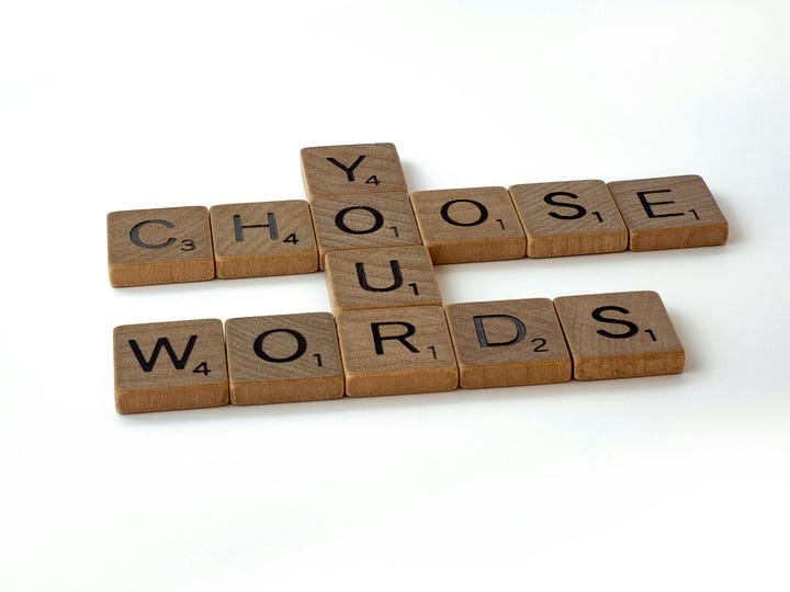 Scrabble tiles that read “Choose your words.”