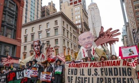 Thousands of pro-Palestinian protesters hold a ‘No Xmas as Usual in a Genocide’ rally and march from Fifth Avenue to Union Square in New York.