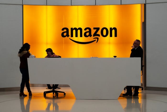 Workers talk in the lobby of an Amazon office in New York