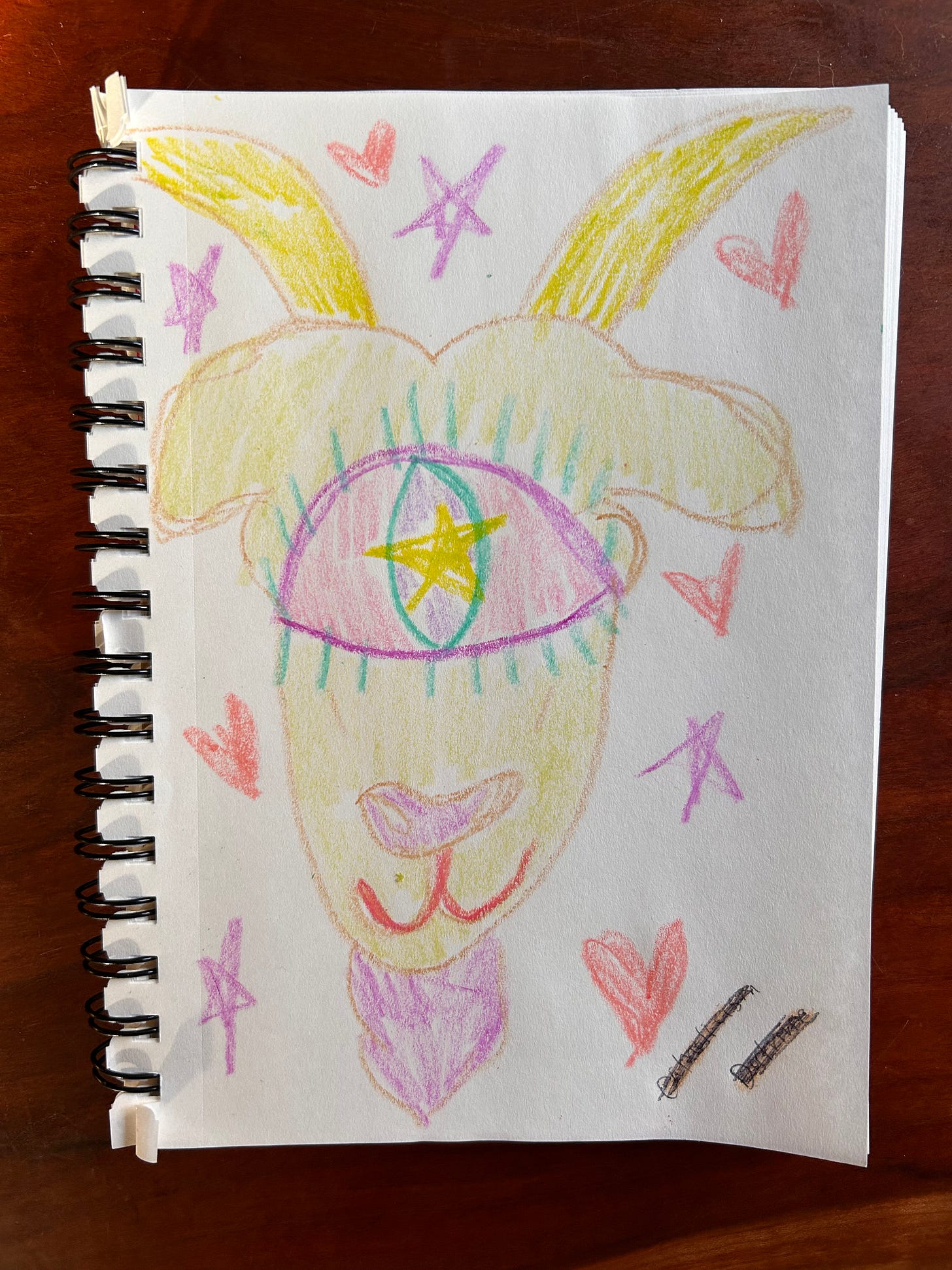 A crayon drawing of a goat surrounded by hearts and stars. In the center of the goat's head is one big eyeball, with a star in the middle.