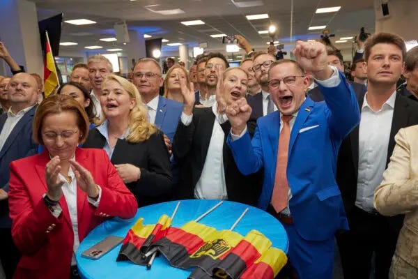 Alice Weidel (C) and Tino Chrupalla (center R), both AfD federal chairmen, cheer at the AfD party headquarters during the forecast for the European elections, in Berlin on June 9, 2024. (Joerg Carstensen/dpa via AP)