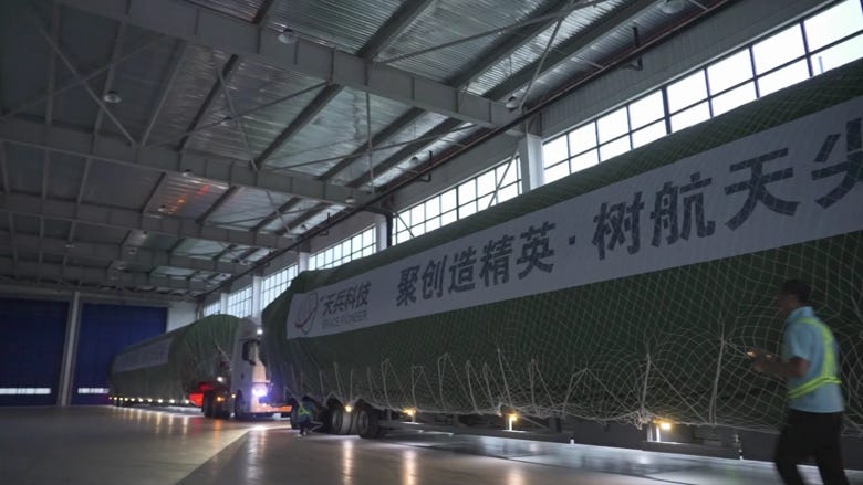 The first-stage of Tianlong-3 before departing on two trucks.