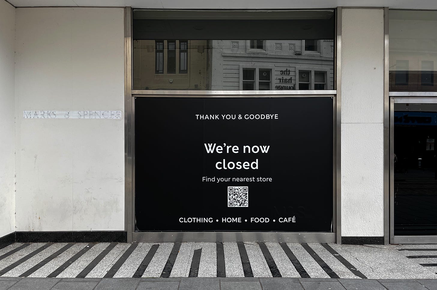 shop entry covered by a black board that reads, thank you and goodbye. We're now closed.