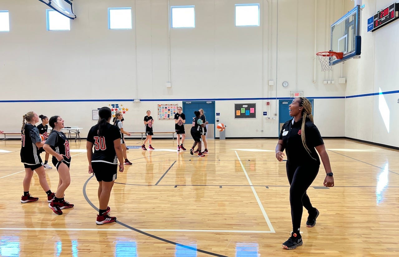 Jenn Mathurin smiles during a drill at Benn's basketball camp.