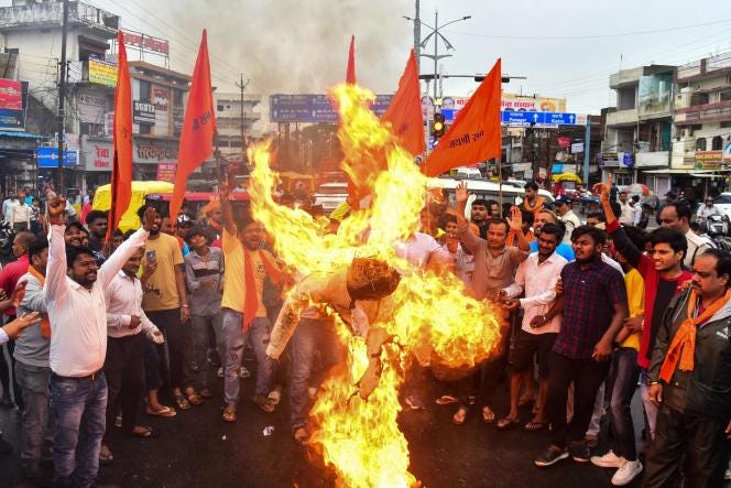 Activists and supporters of Vishwa Hindu Parishad (VHP) and Bajrang Dal burn an effigy during a demonstration against the communal clashes in India's Haryana state, during a protest in Jabalpur on August 2, 2023. 