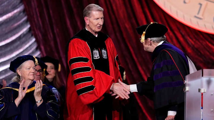 Gov. Mike DeWine shakes hands with Ohio State President Ted Carter during the investiture ceremony at the Greater Columbus Convention Center on Friday, Nov. 8, 2024.