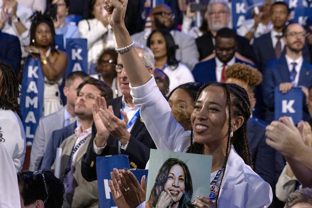 A woman wearing white watched Kamala Harris speak on the final night of the DNC.