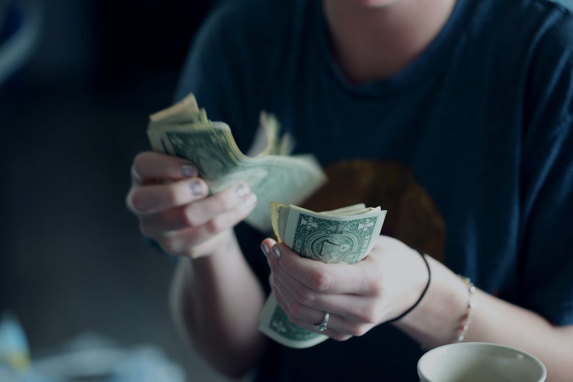 Counting money from passive income - Photo by Alexander Grey on Unsplash