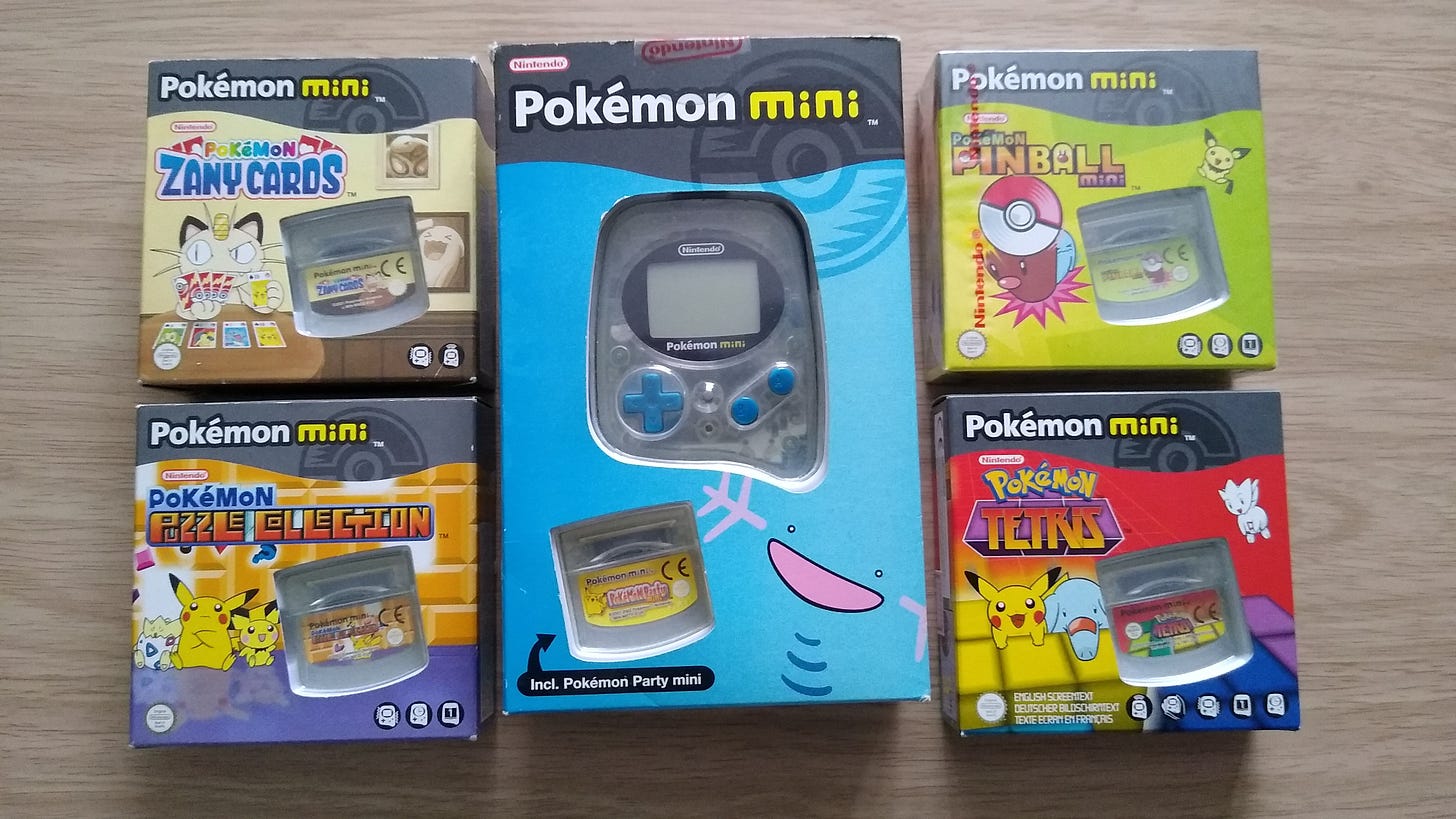 My Pokémon Mini and collection of games, including Pokémon Zany Cards, Pokémon Puzzle Collection, Pokémon Pinball Mini (sealed), and Pokémon Tetris