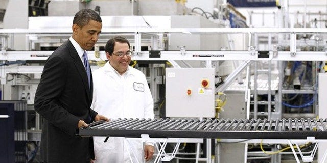 May 26, 2010: President Obama lifts a solar panel as he tours a Solyndra facility in Fremont, Calif.