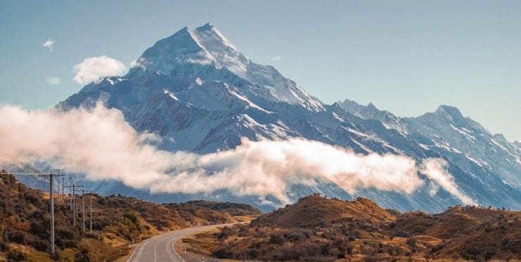 grey road in behind mountain