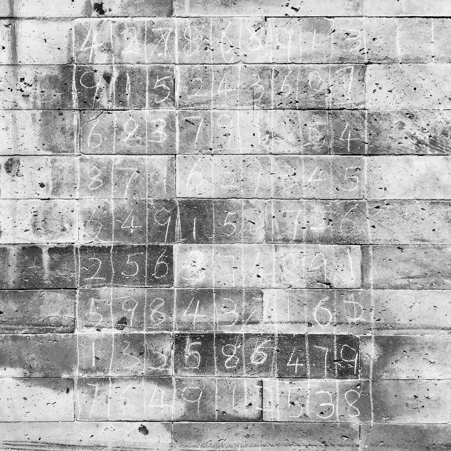 A completed Sudoku puzzle skillfully chalked by kids on a Beijing hutong wall.