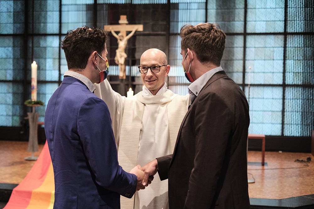 Fr. Christian Olding blesses a gay couple during the blessing service "Love Wins" in the Church of St. Martin in Geldern, Germany, May 6, 2021. (OSV News/KNA/Rudolf Wichert)