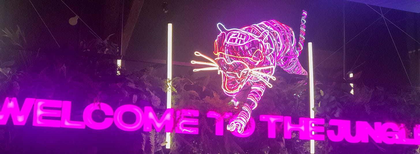 The neon tiger above the sign 'Welcome to the Jungle' at Jungle 8.