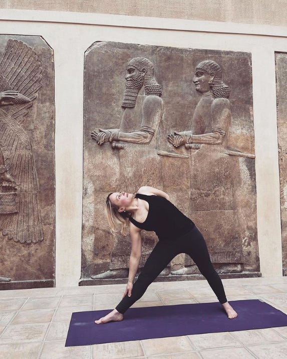Art historian Charlotte Wilkins in triangle pose at the Louvre in Paris, France