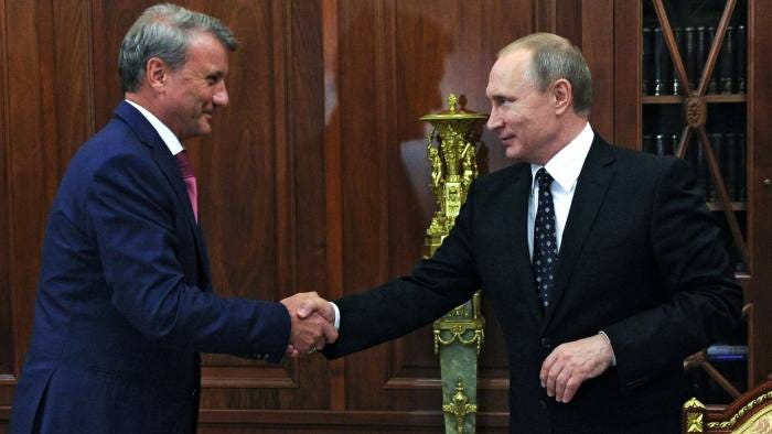 Russian President Vladimir Putin (R) shakes hands with Sberbank CEO Herman Gref during their meeting at the Kremlin in Moscow on August 4, 2016. / AFP / Sputnik / Michael Klimentyev (Photo credit should read MICHAEL KLIMENTYEV/AFP/Getty Images)