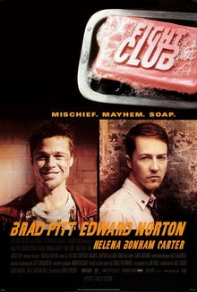 Fight Club film poster: A pink bar of soap with "FIGHT CLUB" embossed is in the upper right. Below are headshots of Brad Pitt smiling in a red jacket and Edward Norton in a white shirt and tie, facing forward. Their names are below the portraits, with "HELENA BONHAM CARTER" in smaller print. Above is "MISCHIEF. MAYHEM. SOAP."