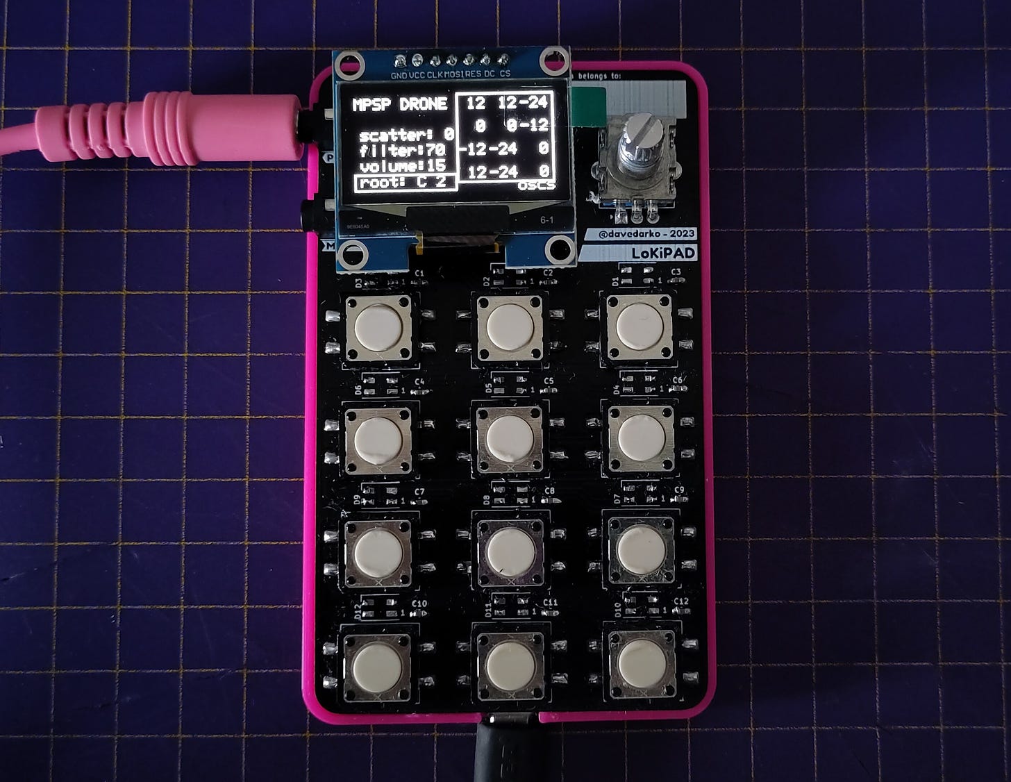 Picture of a 12 button macropad with an OLED and a encoder knob