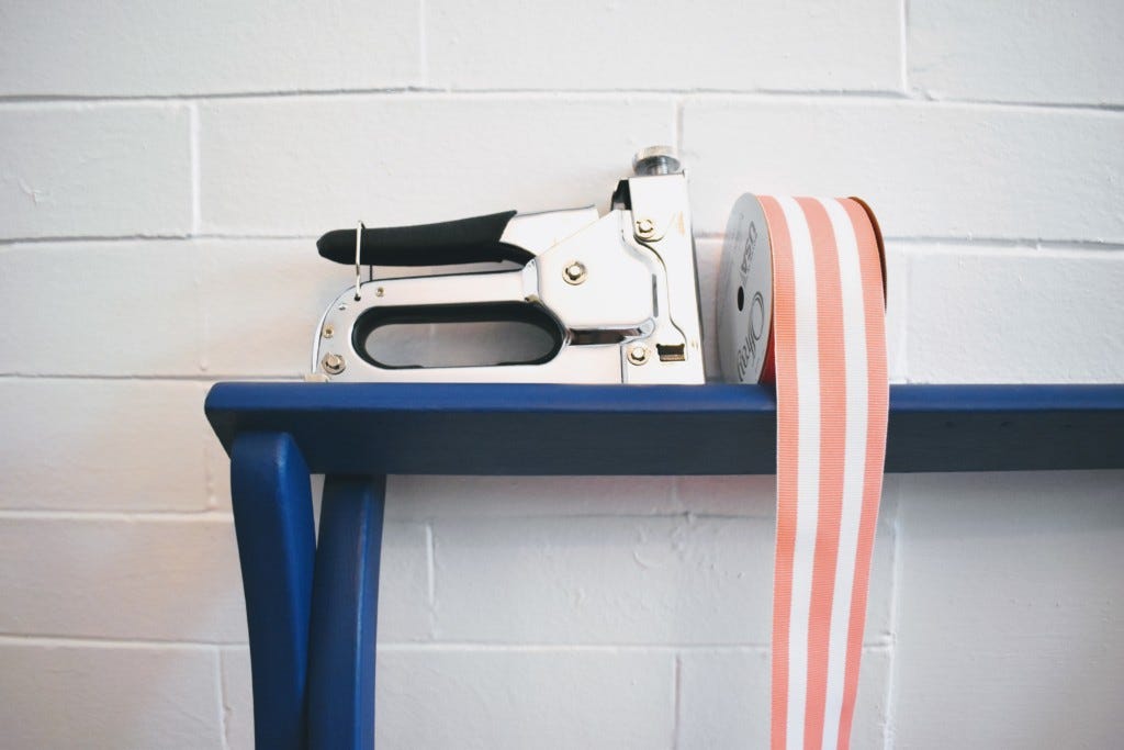 staple gun and pink striped ribbon