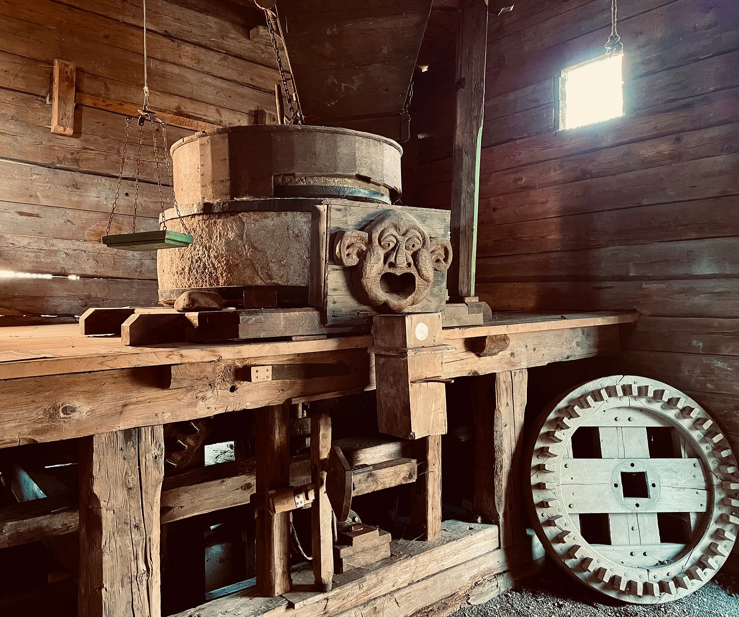 Interior of the mill in Ebergötzen, Germany, famously associated with Wilhelm Busch’s Max and Moritz. The wooden structure features a carved stone face, old mill equipment, and beams, recalling the mischief and grim fate of the iconic characters from this classic German children’s book.