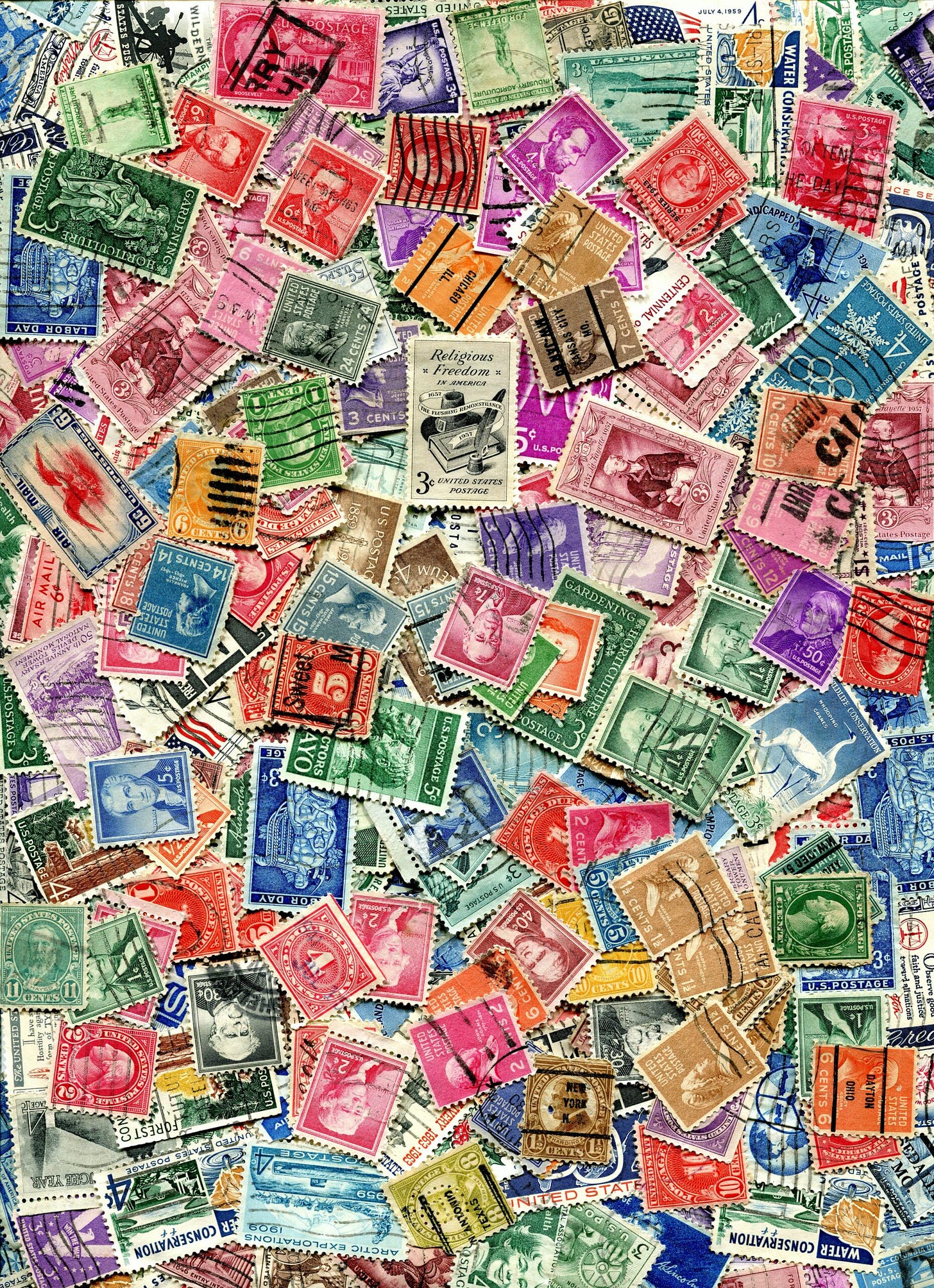 a pile of different colored postage stamps
