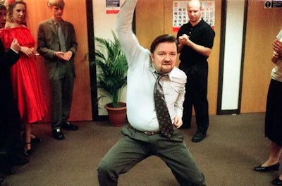 A screen shot from the BBC version of The Office, of David Brent being cringe