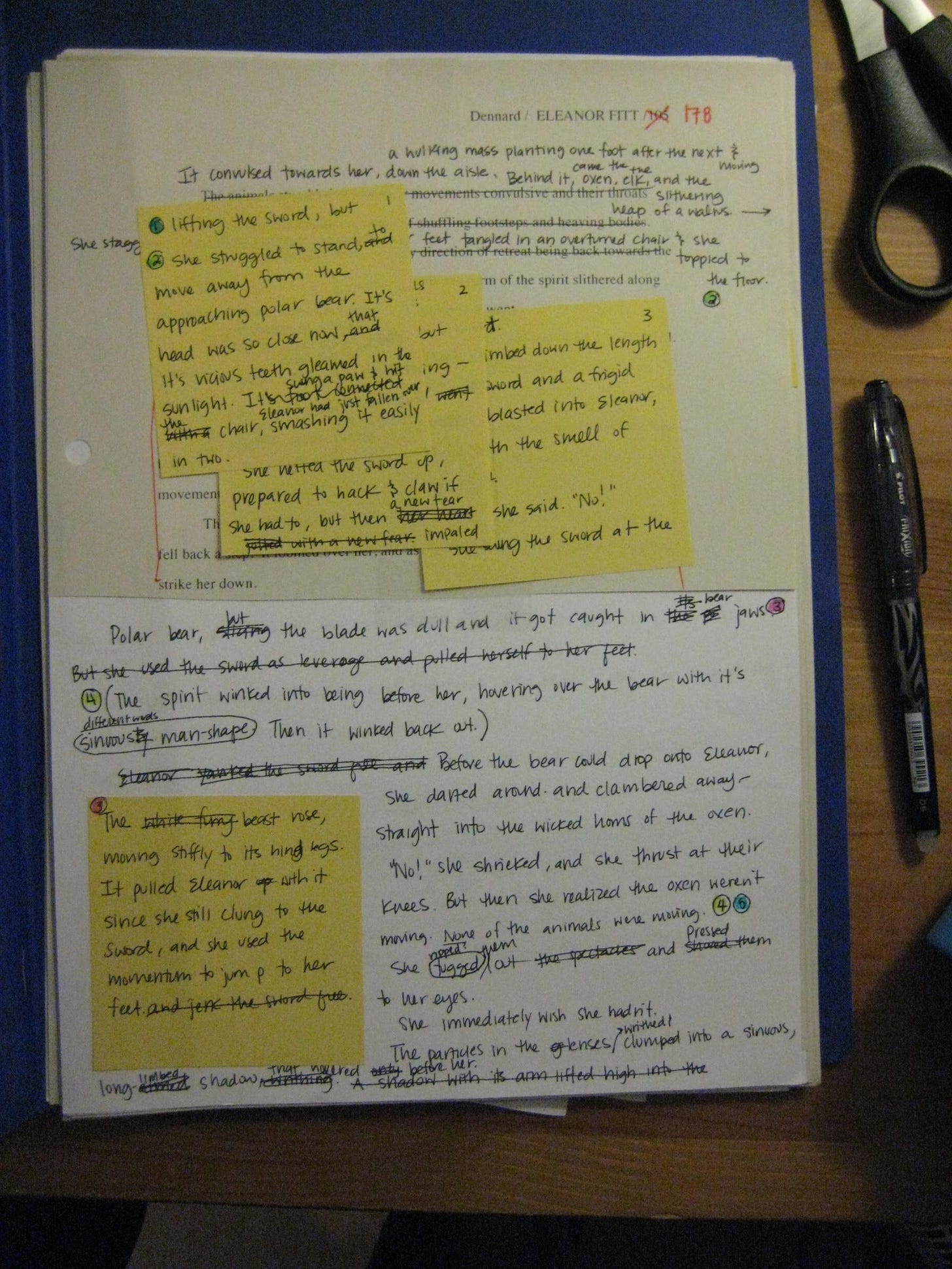 A photo of Susan's first developmental edit for her debut novel, all done by hand. The image shows a single page with post its, handwritten changes to the text, and literal cut-outs of other pages pasted onto this one. It's a mess! But this is how she learned.