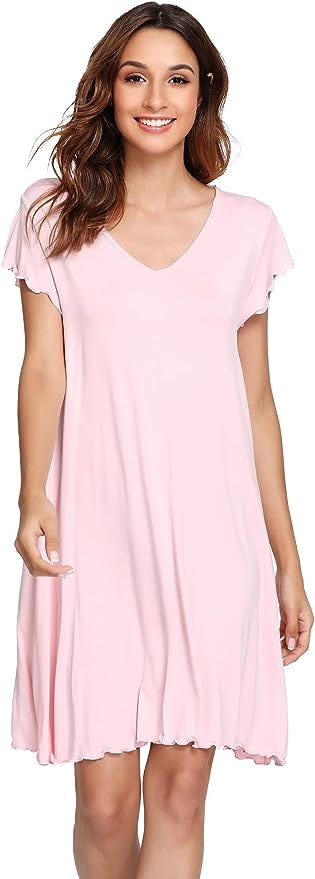 Brunette woman in short sleeve, knee length, light pink nightgown