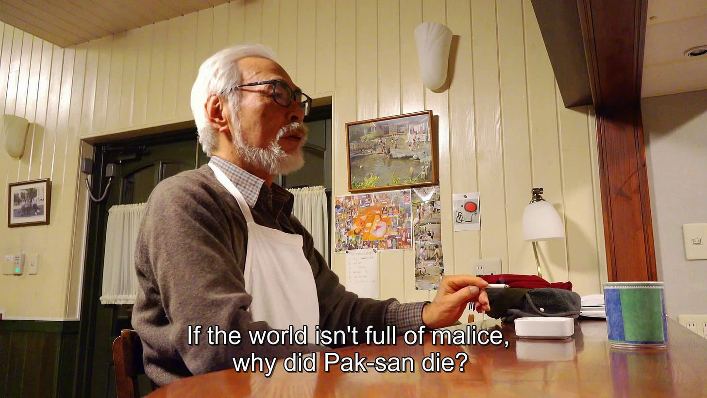 A shot of Hayao Miyazaki sitting at a desk saying "If the world isn't full of malice, why did Pak-san die?"