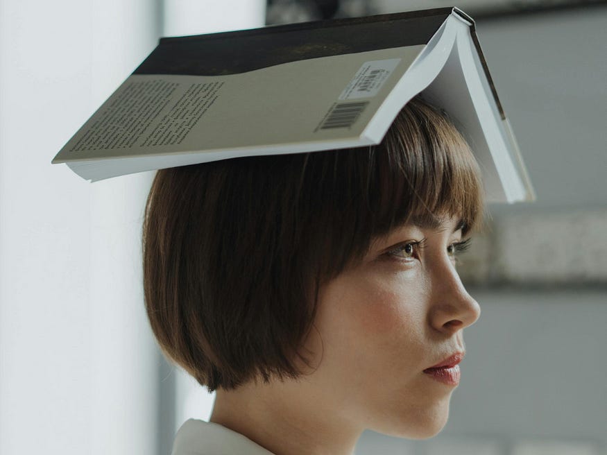 woman with book on her head