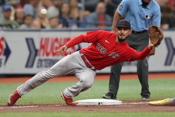 Boston Red Sox third baseman Matthew Lugo reaches to make a catch a throw from the catcher during the MLB spring training game between the Boston Red...