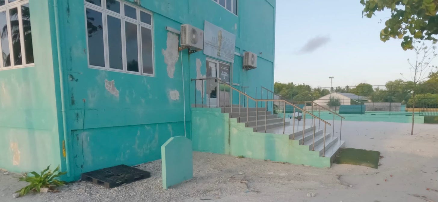 A flight of stairs leads into a building