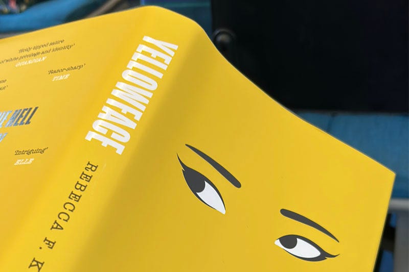 Cover of the book 'Yellowface' by Rebecca F Kuang, featuring a yellow cover and a pair of feminine-looking eyes.