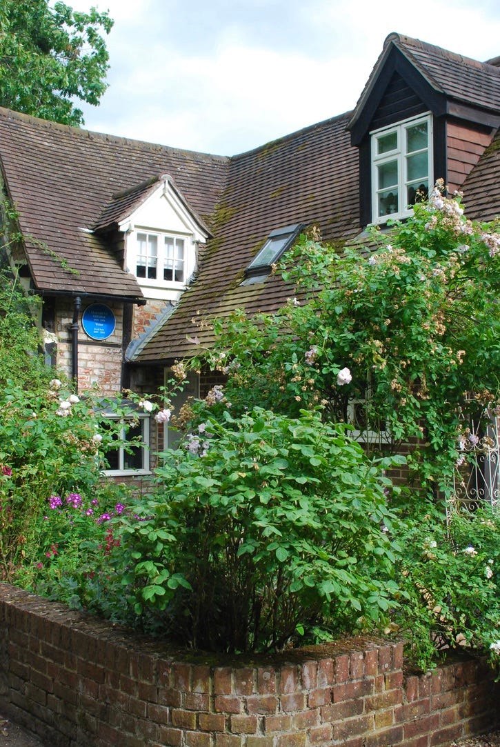 Rose Cottage with its abundant borders and author Elizabeth Goudge’s blue plaque.