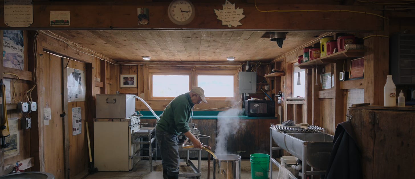 David Isham tending to maple syrup production during sugaring season.