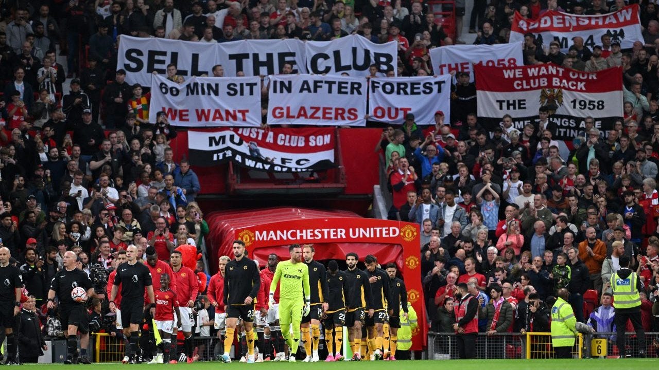 Manchester United Stadium fans with anti-Glazer signs